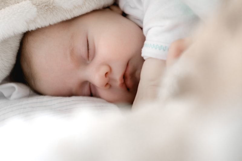 Mother practicing pelvic floor exercises safely at home while with her baby